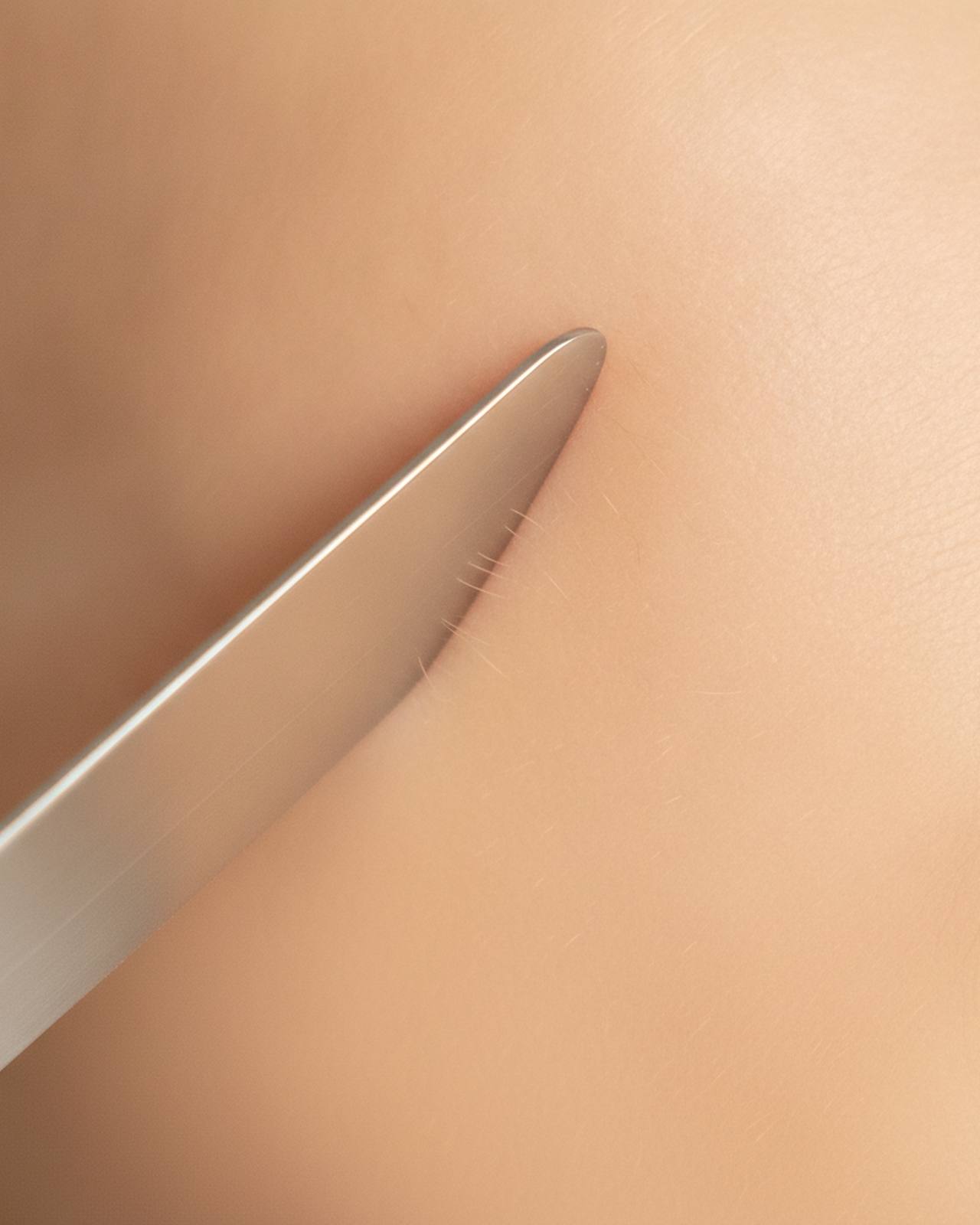 A dermaplaning blade gliding across cheek skin