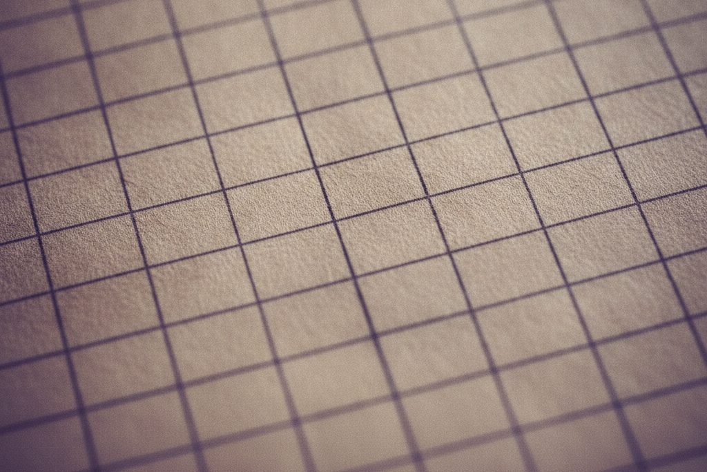 An abstract macro of ruled archival ledger paper in raking light